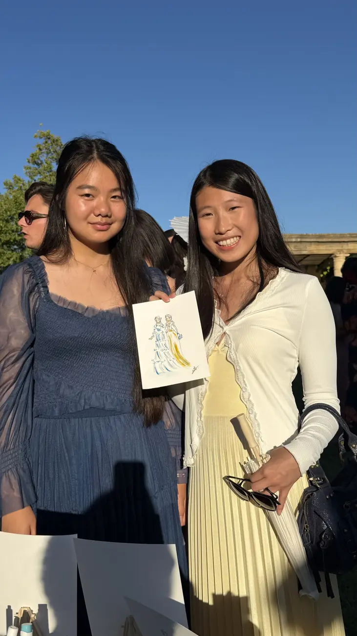 Deux invitées souriantes montrant leur portrait aquarelle au Château de Sannes